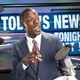 TV/Radio news anchor with prompter and microphone.